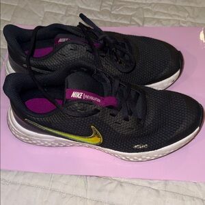Nike Revolution Women's Black and Gold Athletic Shoes